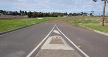 An Unfinished Road Leads To Undeveloped Vacant Land In A Melbourne’s Western Suburb. Tarneit VIC Australia. Concept Of Real Estate Development, Housing Market, New Suburb And Land For Sale.