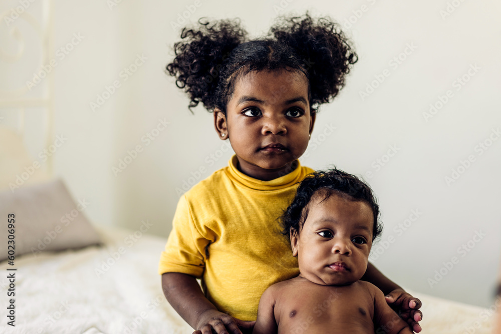 Portrait of cute adorable little african american baby and sister girl ...