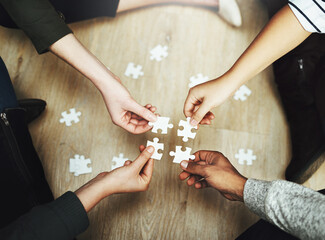 Poster - Hands, business people and puzzle in circle, huddle or teamwork for problem solving, solution or game in top view. Group, together and helping with support, synergy and team building on office floor