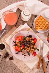 Wall Mural - Waffles with strawberries and chocolate cream.