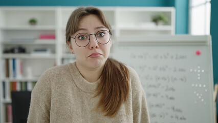 Sticker - Young blonde woman student standing with i dont know expression at street