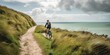 © koldunova - An enthusiastic cyclist riding along a scenic coastal path, emphasizing the health benefits and enjoyment of outdoor exercise, concept of Active lifestyle, created with Generative AI technology