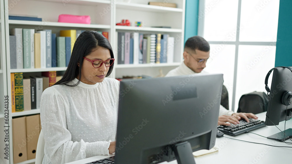 Study With Computer Man and woman students using computer studying at university classroom ...