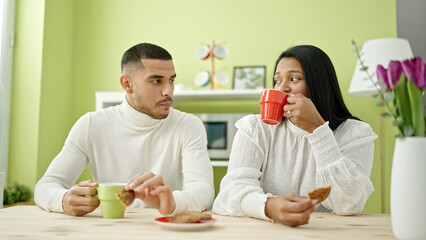 Poster - Man and woman couple having breakfast sitting on table at home