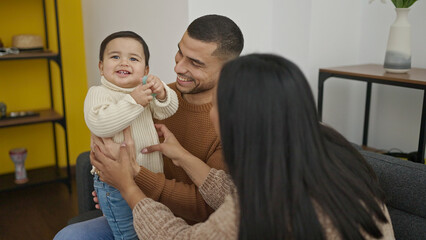 Poster - Couple and son sitting on sofa playing at home