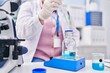 © Krakenimages.com - Young beautiful plus size woman scientist pouring liquid on test tube weighing liquid at laboratory
