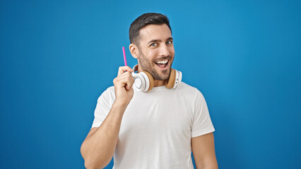 Poster - Young hispanic man wearing headphones having idea over isolated blue background