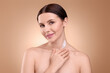 © New Africa - Beautiful woman with smear of body cream on her neck against light brown background