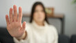 © Krakenimages.com - Young beautiful hispanic woman doing stop gesture with hand at home