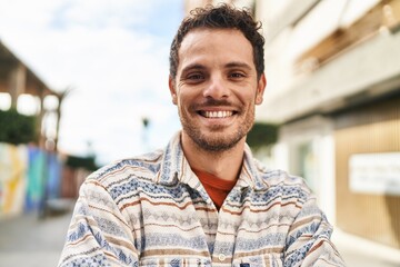 Canvas Print - Young hispanic man smiling confident standing at street