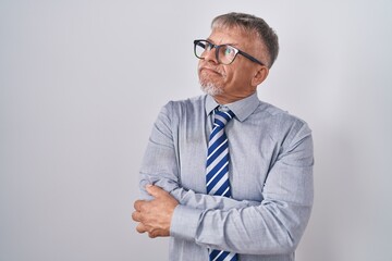 Sticker - Hispanic business man with grey hair wearing glasses looking to the side with arms crossed convinced and confident