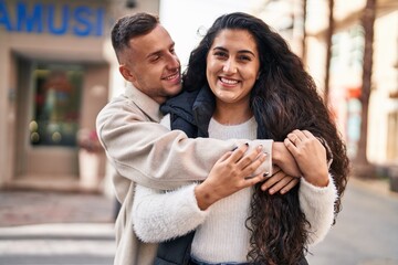 Poster - Man and woman couple hugging each other standing at street