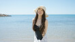 © Krakenimages.com - Young chinese woman tourist smiling confident wearing swimsuit and summer hat at seaside