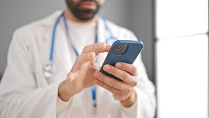 Sticker - Young hispanic man doctor using smartphone at clinic