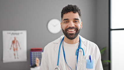 Sticker - Young hispanic man doctor smiling confident standing at clinic