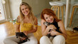 © Krakenimages.com - Two women smiling confident sitting on floor with chihuahuas at home