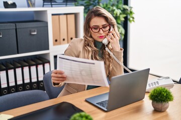 Wall Mural - Young woman business worker talking on telephone working at office