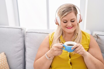 Sticker - Young woman listening to music drinking coffee at home