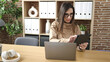 © Krakenimages.com - Beautiful hispanic woman business worker using touchpad and laptop at office