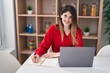 © Krakenimages.com - Young hispanic woman studying sitting on table at home