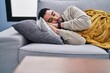 © Krakenimages.com - Young arab man lying on sofa sleeping at home