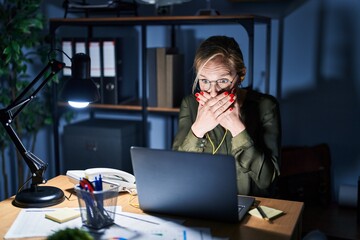 Sticker - Young blonde woman working at the office at night shocked covering mouth with hands for mistake. secret concept.