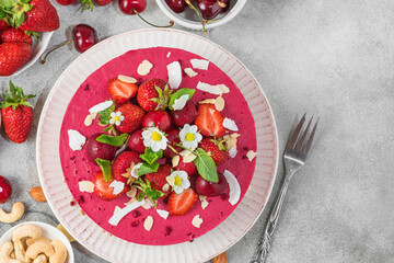 Wall Mural - Vegan dessert. Raw berry cashew cake with fresh strawberries, cherries and nuts in a plate. Top view