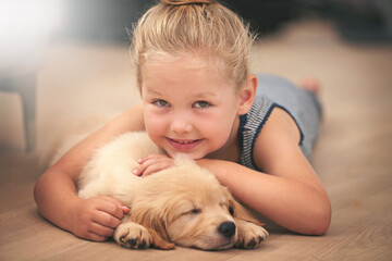 Girl hug her puppy in portrait, relax at home and happy with sleeping golden retriever and child with smile. Happiness, pet care and love with female kid with her domestic animal lying on wood floor