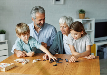 Wall Mural - grandchild family child grandparent grandfather grandmother game playing domino granddaughter grandson leisure entertainment fun hobby