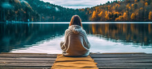 Calm Morning Meditation By The Lake. Young Woman Outdoors On The Pier. Wellbeing And Wellness Soul Concept. Summer Nature. Woman Feeling Freedom, Enjoying Vacation. No Stress, Calm Mind, Relax