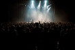 © MVProductions - Silhouettes of concert crowd in front of bright stage lights at rock or metal concert, generative ai
