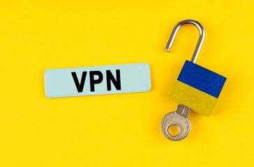 Poster - On the yellow surface is an open lock with a key and a sticker with the inscription - VPN