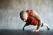 Gym, man and one arm push up for exercise performance, workout determination and sports training focus. Athlete discipline, strength endurance mockup or active male person concentrate on floor pushup