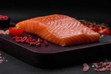 Fresh raw salmon red fish fillet with salt and spices