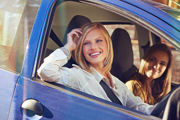 Wall Mural - Car, travel and friends smile, happy and on urban city journey, transport or street road trip in motor vehicle. Automobile transportation, driver happiness and driving woman looking at window view