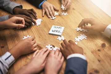 Poster - Teamwork, puzzle and hands of business people in collaboration in a meeting together planning strategy at work. Circle, professional and group in a table with synergy as a workforce for innovation