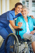 © GR/peopleimages.com - Portrait, caregiver or happy elderly woman in a wheelchair in hospital helping a mature patient for support. Smile, disabled or healthcare social worker smiling with a senior person with a disability