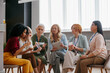 © gstockstudio - Group of confident mature women examining beauty products during specialized conference