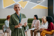 © gstockstudio - Happy mature woman looking at camera while visiting group training class for females