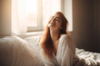 © MVProductions - Happy smiling woman stretching on bed in the morning, generative ai