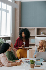 Canvas Print - Group of mature women communicating while having business meeting in office