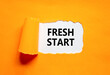 © Dzmitry - Fresh start and motivational symbol. Concept words Fresh start on beautiful white paper. Beautiful orange table orange background. Business motivational and Fresh start concept. Copy space.