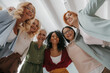 © gstockstudio - Low angle view of group of confident mature women embracing and smiling at camera
