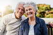 © Anne B/peopleimages.com - Senior couple, portrait and relaxing together outdoors or romantic retirement and park bench. Elderly, partners and affectionate faces or in love or date and feeling care or happy outside garden