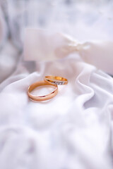 beautiful wedding rings on white for bride and groom