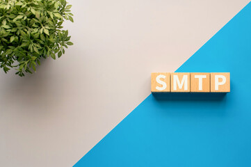 Poster - There is wood cube with the word SMTP. It is an abbreviation for Simple Mail Transfer Protocol as eye-catching image.
