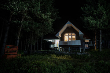Wall Mural - mountain night landscape of building at forest at night with moon or vintage country house at night 