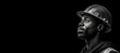 © JoelMasson - Black and white photorealistic studio portrait of a construction worker with hard hat on black background. Generative AI illustration