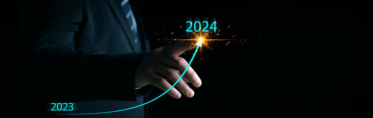 New years 2024 start up investment new business and finance. Businessman hand pointing graph on target 2024. Stock market, Business growth, progress or succe