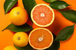 Fresh ripe mandarins, grapefruit and oranges with green leaves on orange background
